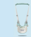 Baby safety harness with green straps on a light blue background
