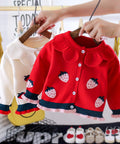 Red children's jacket with strawberry pattern on a hanger