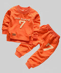 Orange children's outfit with 'Just looking 7' text on a textured surface