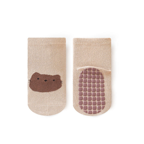 Pair of beige socks with a brown bear face design on a white background