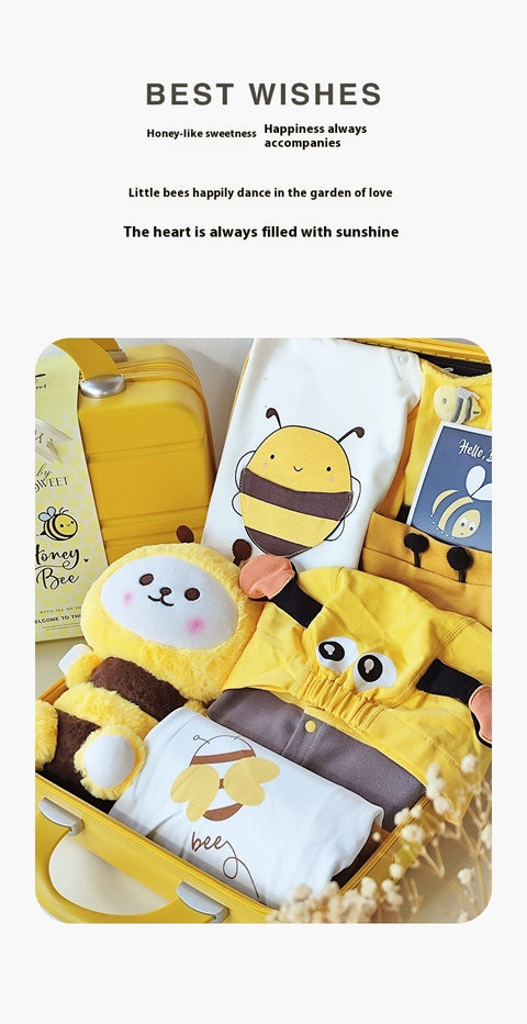 Bee-themed product set with a suitcase, pillow, and blanket on a white .