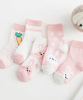 Set of baby socks with cartoon designs on a white surface