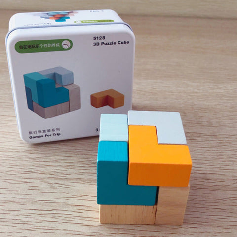 Wooden 3D puzzle cube with packaging on a wooden surface