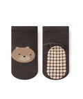 Black socks with a bear face design and textured sole on a white background
