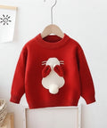 Red sweater with a cartoon dog face design on a hanger against a white wall.