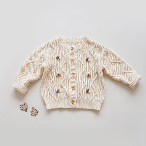 Suéter de punto con detalles de pompones coloridos