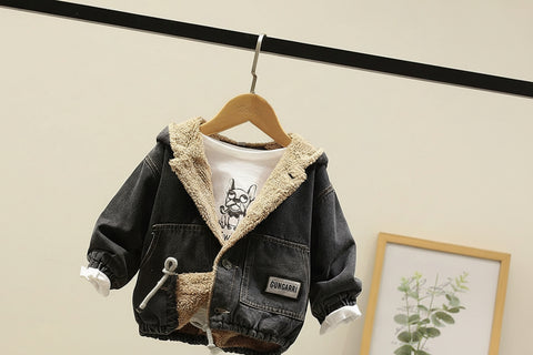 denim jacket with fleece lining on a hanger against a neutral wall.