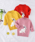 Three children's sweaters in red, yellow, and pink with rabbit designs on a white background.