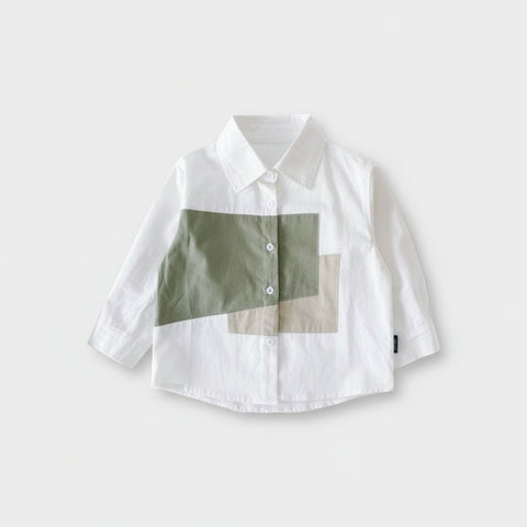 White shirt with green and beige patchwork design on a white background