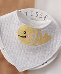 Baby bib with fish design on a white background