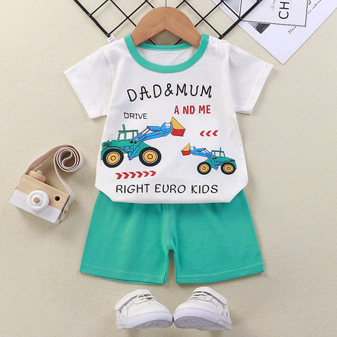 Children's outfit with t-shirt and shorts on a hanger, featuring cartoon tractors and text.