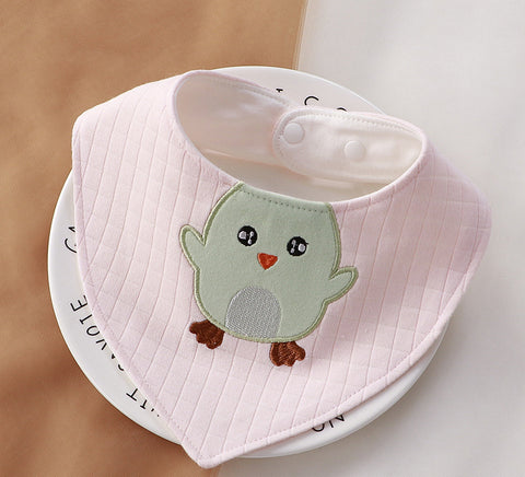 Baby bib with a cartoon bird design on a white surface