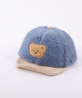 Blue children's cap with a bear emblem on a white background