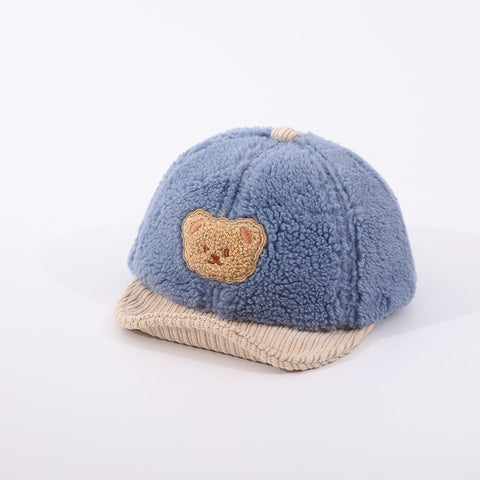 Blue children's cap with a bear emblem on a white background