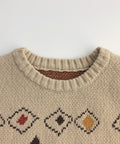 Beige sweater with diamond pattern on a white background