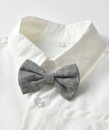 Black and white herringbone bow tie on a white shirt with a light gray background