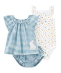 Two baby rompers, one blue checkered with a bunny design and one white with gold polka dots, on a white background.