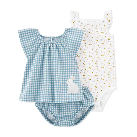 Two baby rompers, one blue checkered with a bunny design and one white with gold polka dots, on a white background.
