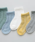Set of five baby socks in various colors on a white background