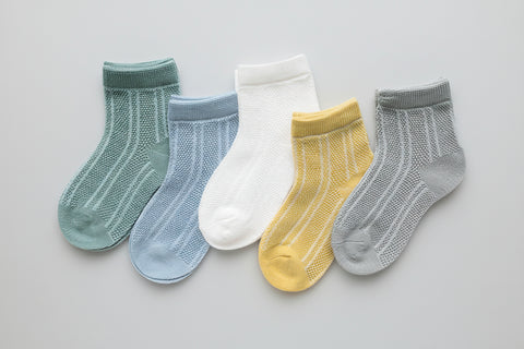 Set of five baby socks in various colors on a white background