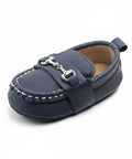 Navy blue baby shoe with a strap on a white background