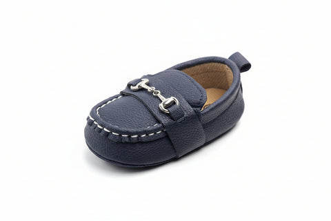 Navy blue baby shoe with a strap on a white background