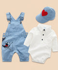 Baby outfit set with blue overalls, white romper, and cap on a white background