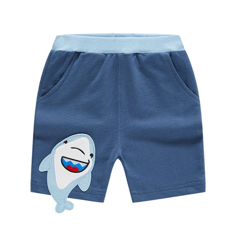 Blue shorts with a shark applique on a white background