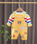 Children's outfit with yellow overalls and striped shirt.