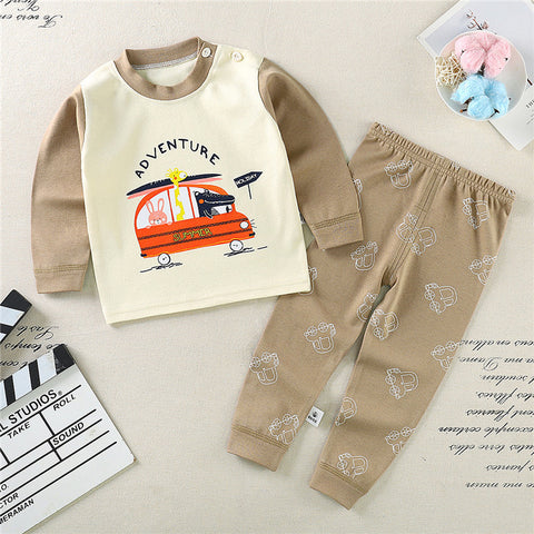 Children's clothing set with a shirt and pants on a textured surface.