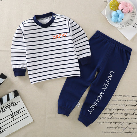 Children's outfit with striped shirt and navy pants on a beige surface