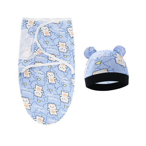 Baby swaddle and hat set with teddy bear pattern on a white background
