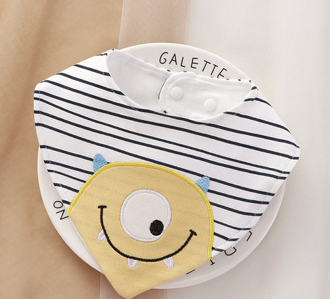 Baby bib with striped pattern and cartoon monster design on a beige background