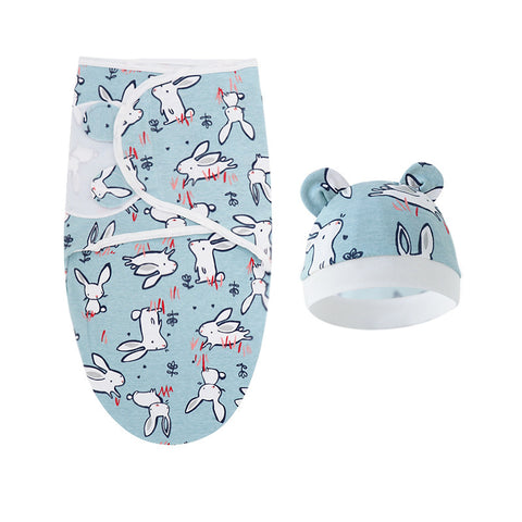 Baby swaddle and hat set with bunny pattern on a light blue background