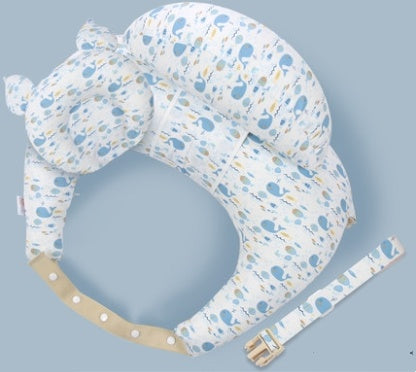 Baby support pillow with whale pattern on a light blue background