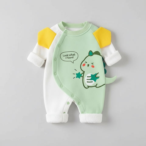 Green baby romper with dinosaur design on a gray background