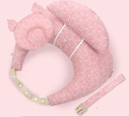 Pink baby support pillow with straps on a light pink background