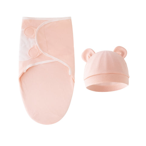 Pink baby blanket and hat set on a white background