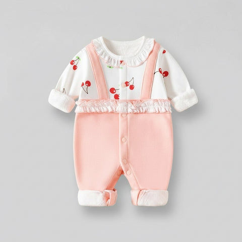 Baby outfit with white top and pink pants on a gray background