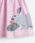 Dress with rabbit applique on a pink geometric pattern