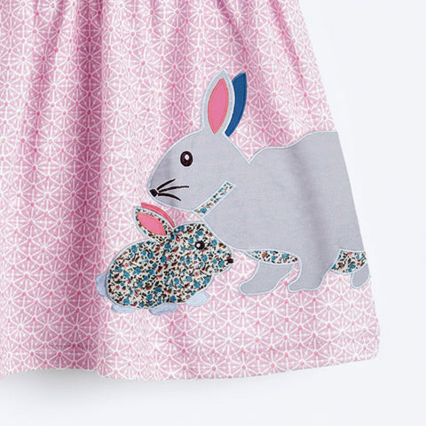 Dress with rabbit applique on a pink geometric pattern