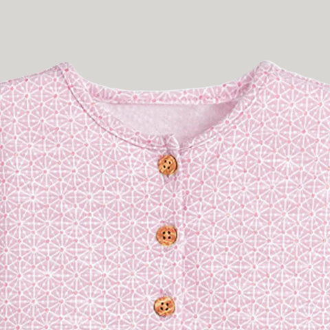 Close-up of a pink patterned shirt with buttons on a white background