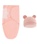 Pink baby swaddle blanket and hat set on a white background