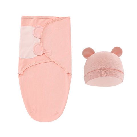 Pink baby swaddle blanket and hat set on a white background