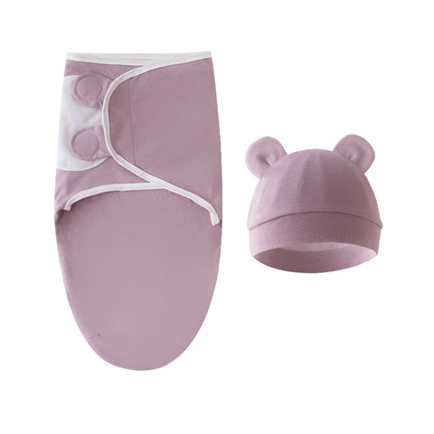 Baby swaddle and hat set in pink on a white background
