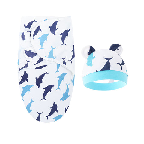 Baby swaddle and hat set with dolphin pattern on a white background