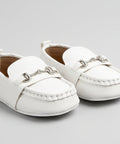 Pair of white children's loafers on a light gray background
