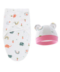 Baby swaddle with colorful patterns and a matching hat with pink trim on a white background