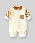 Baby onesie with checkered sleeves and bear face on a gray background