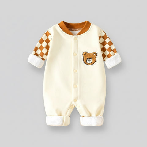 Baby onesie with checkered sleeves and bear face on a gray background